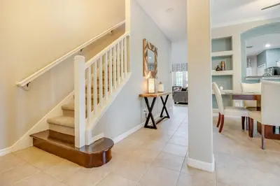 a staircase in a home with a dining room at Emerald Escape in Kissimmee