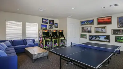a living room with a ping pong table in it at 3 bedrooms pool home Retreat Close to Disney in Orlando