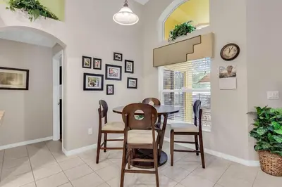 a dining room with a table and chairs at 4 bedrooms pool home gated resort of Veranda Palms in Kissimmee