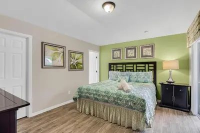 a bedroom with a bed with blue and green walls at 4 bedrooms pool home gated resort of Veranda Palms in Kissimmee