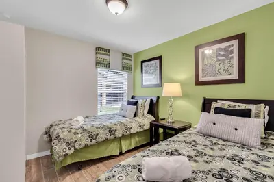 a bedroom with two beds and a window at 4 bedrooms pool home gated resort of Veranda Palms in Kissimmee