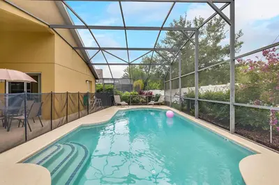 an indoor swimming pool with a glass roof at 4 bedrooms pool home gated resort of Veranda Palms in Kissimmee