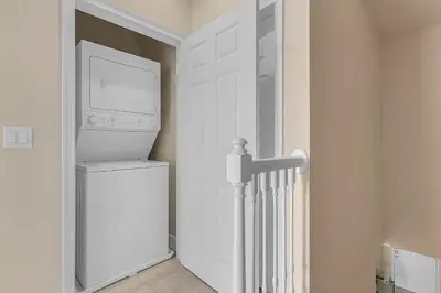 a white laundry room with a washer and dryer at 3 bedrooms pool home with clubhouse amenities Retreat in Orlando