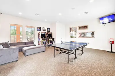 a living room with a ping pong table in it at 3 bedrooms pool home with clubhouse amenities Retreat in Orlando
