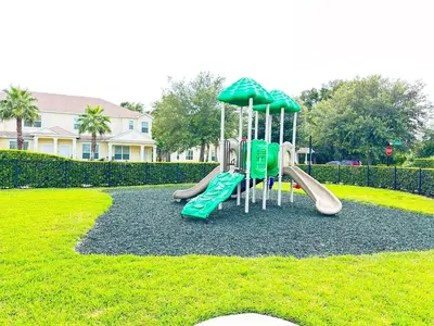 a playground with a slide in a park at 3 bedrooms pool home with clubhouse amenities Retreat in Orlando
