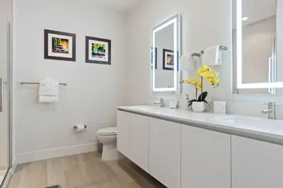a white bathroom with a sink and a toilet at 3 bedrooms pool home Hidden Forest Resort Amenities in Orlando