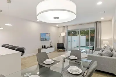 a living room with a glass table and chairs at 3 bedrooms pool home Hidden Forest Resort Amenities in Orlando