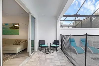 a living room with a couch and a table and chairs at 3 bedrooms pool home Hidden Forest Resort Amenities in Orlando