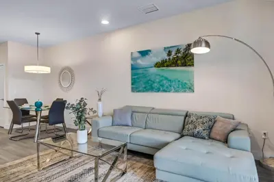 a living room with a blue couch and a table at 3 bedrooms pool home Hidden Forest Resort Amenities in Orlando