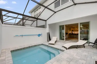 a swimming pool in the backyard of a house at 3 bedrooms pool home Hidden Forest in Orlando