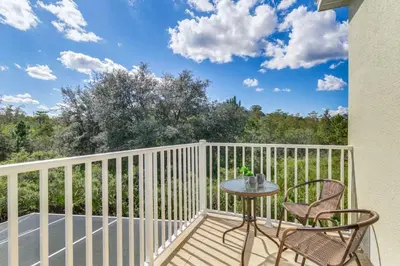 a patio with a table and chairs on a balcony at 3 bedrooms pool home with clubhouse amenities Retreat in Orlando
