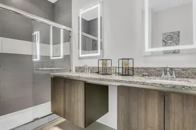 a bathroom with two sinks and two mirrors at 3 bedrooms pool home with clubhouse amenities Retreat in Orlando