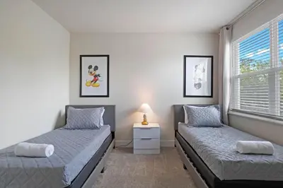 a bedroom with two beds and a window at 3 bedrooms pool home Hidden Forest Resort Amenities in Orlando