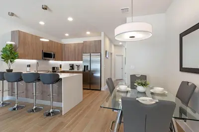 a kitchen and dining room with a glass table and chairs at 3 bedrooms pool home Hidden Forest Resort Amenities in Orlando