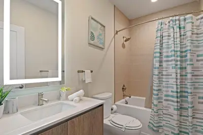a bathroom with a sink and a toilet and a tub at 3 bedrooms pool home Hidden Forest Resort Amenities in Orlando