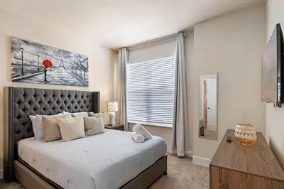 a bedroom with a large bed and a window at 3 bedrooms pool home Hidden Forest Resort Amenities in Orlando