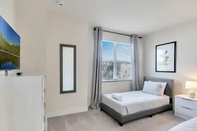 a white bedroom with a bed and a window at 3 bedrooms pool home Hidden Forest Resort Amenities in Orlando