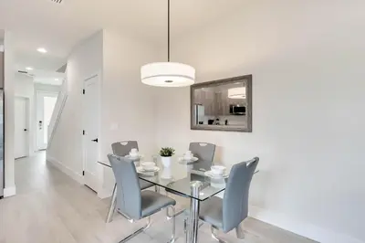 a dining room with a glass table and chairs at 4 bedrooms pool home Hidden Forest Resort Amenities in Orlando