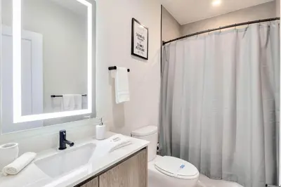 a bathroom with a sink and a toilet and a mirror at 4 bedrooms pool home Hidden Forest Resort Amenities in Orlando