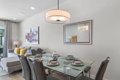 a dining room with a glass table and chairs at 3 bedrooms pool home Hidden Forest Resort Amenities in Orlando
