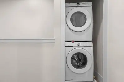 a washer and a washing machine in a corner at 3 bedrooms pool home Hidden Forest Resort Amenities in Orlando
