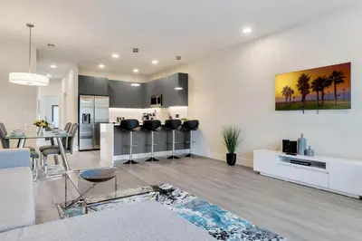 a living room with a kitchen and a dining room at 3 bedrooms pool home Hidden Forest Resort Amenities in Orlando