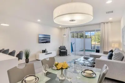 a dining room and living room with a table and chairs at 3 bedrooms pool home Hidden Forest Resort Amenities in Orlando