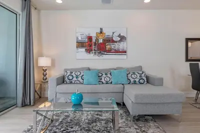 a living room with a couch and a table at 3 bedrooms pool home Hidden Forest Resort Amenities in Orlando