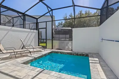 a swimming pool in the backyard of a house at TR17126 - 3 Bed-3 bath w/pool near Disney sleeps 6 in Orlando