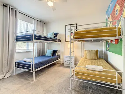 a room with two bunk beds and a bed at 3 bedrooms pool home Hidden Forest Resort Amenities in Orlando