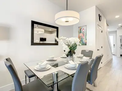 a dining room with a glass table and chairs at 3 bedrooms pool home Hidden Forest Resort Amenities in Orlando