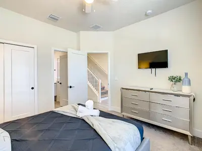 a bedroom with a bed and a tv on a wall at 3 bedrooms pool home Hidden Forest Resort Amenities in Orlando