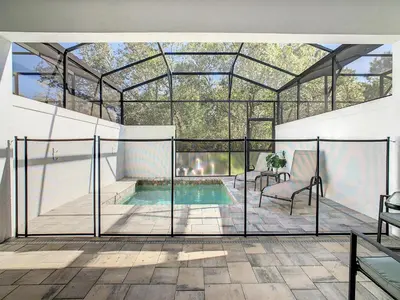 an internal view of a glass house with a pool at 3 bedrooms pool home Hidden Forest Resort Amenities in Orlando