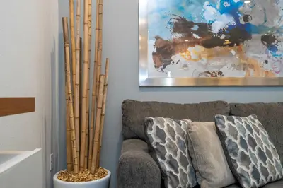 a living room with a couch and some bamboo poles at Gorgeous 4 Suites DREAM Villa 5 min to Disney in Orlando