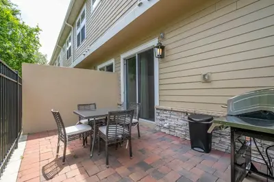 a patio with a table and chairs and a grill at Gorgeous 4 Suites DREAM Villa 5 min to Disney in Orlando