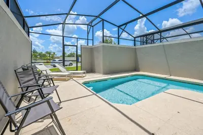 a swimming pool in a house with a glass roof at Magical Retreat, Spacious villa 10 min from Disney in Kissimmee