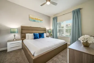 a bedroom with a large bed and a window at Magical Retreat, Spacious villa 10 min from Disney in Kissimmee