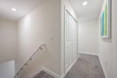 an empty hallway with a white door and stairs at Magical Retreat, Spacious villa 10 min from Disney in Kissimmee