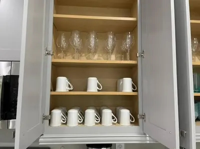 a cupboard with cups and wine glasses in it at Luxury 6 BR 6 Bath @Encore Resort Pool Spa Grill. in Orlando