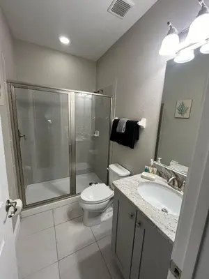a bathroom with a shower and a toilet and a sink at Luxury 6 BR 6 Bath @Encore Resort Pool Spa Grill. in Orlando