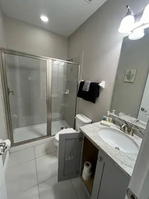 a bathroom with a shower and a toilet and a sink at Luxury 6 BR 6 Bath @Encore Resort Pool Spa Grill. in Orlando