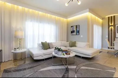 a living room with a white couch and a table at Amazing Unbeatable Experience Themed Home w/ Private Pool and Resort in Kissimmee