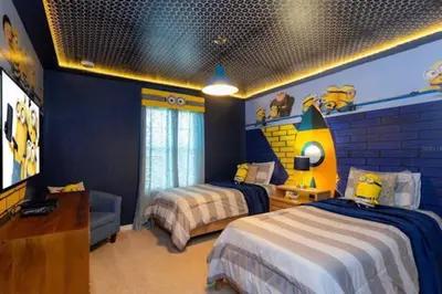 a bedroom with two beds and a tv in it at Amazing Unbeatable Experience Themed Home w/ Private Pool and Resort in Kissimmee