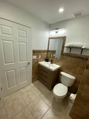 a bathroom with a toilet and a sink at Villa at Island Club in Kissimmee