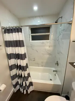 a bathroom with a shower and a tub and a toilet at Villa at Island Club in Kissimmee