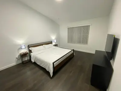a white bedroom with a bed and a window at Villa at Island Club in Kissimmee