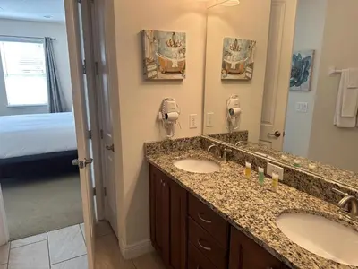 a bathroom with two sinks and a large mirror at 6 bedrooms pool home Encore Reunion Resort Gated in Orlando