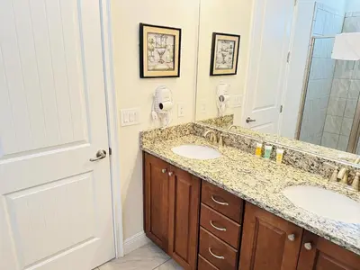 a bathroom with two sinks and a mirror at 6 bedrooms pool home Encore Reunion Resort Gated in Orlando