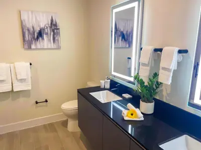a bathroom with a sink and a toilet and a mirror at 3 bedrooms pool home Hidden Forest Resort Amenities in Orlando