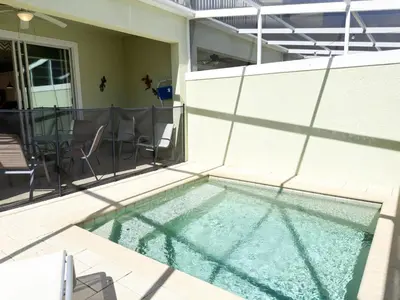 a swimming pool in the backyard of a house at Stylish 3-BR with Private Pool & Conservation View in Orlando